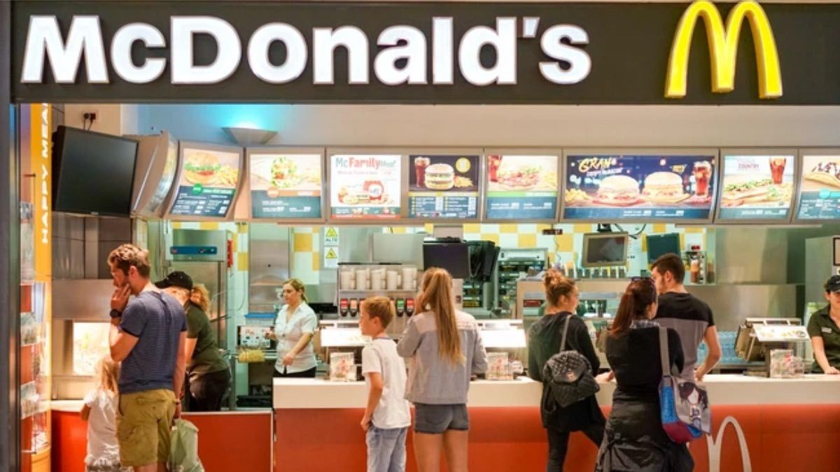 Interior de un McDonald's con gente comprando en el mostrador