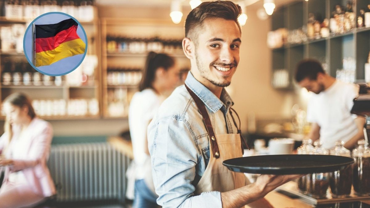 Un camarero lleva una bandeja.