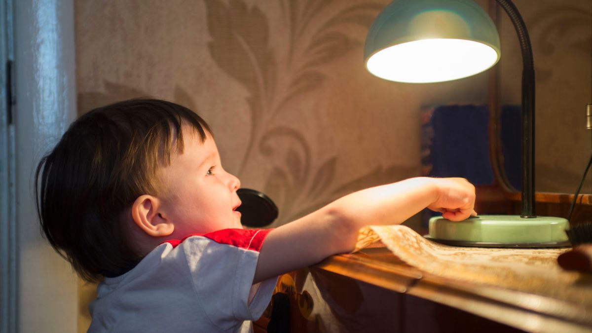Niño encendiendo una lámpara Niño encendiendo una lámpara
