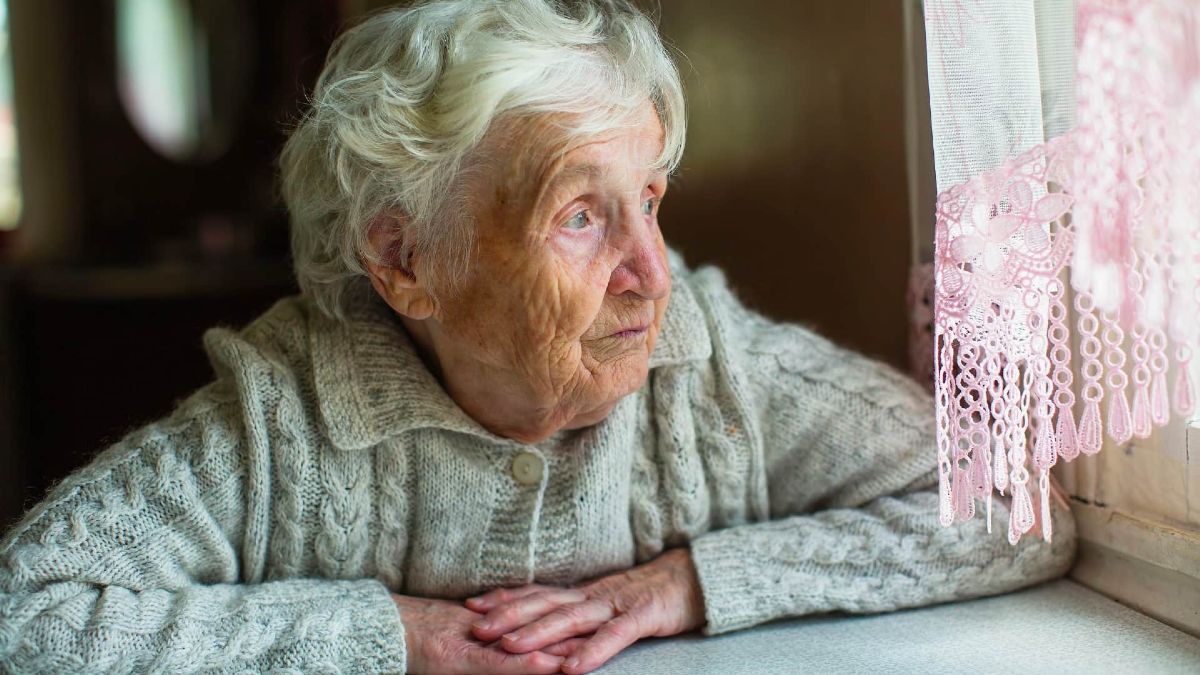 Una anciana mirando por la ventana