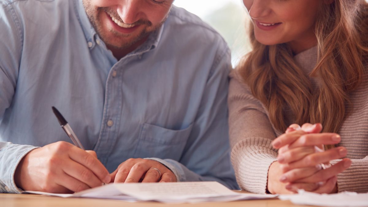 Una pareja firmando una hipoteca