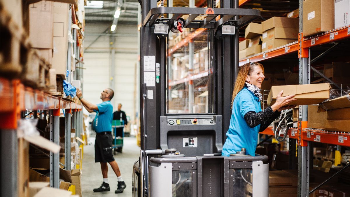 Dos trabajadores ordenando pedidos en un almacén