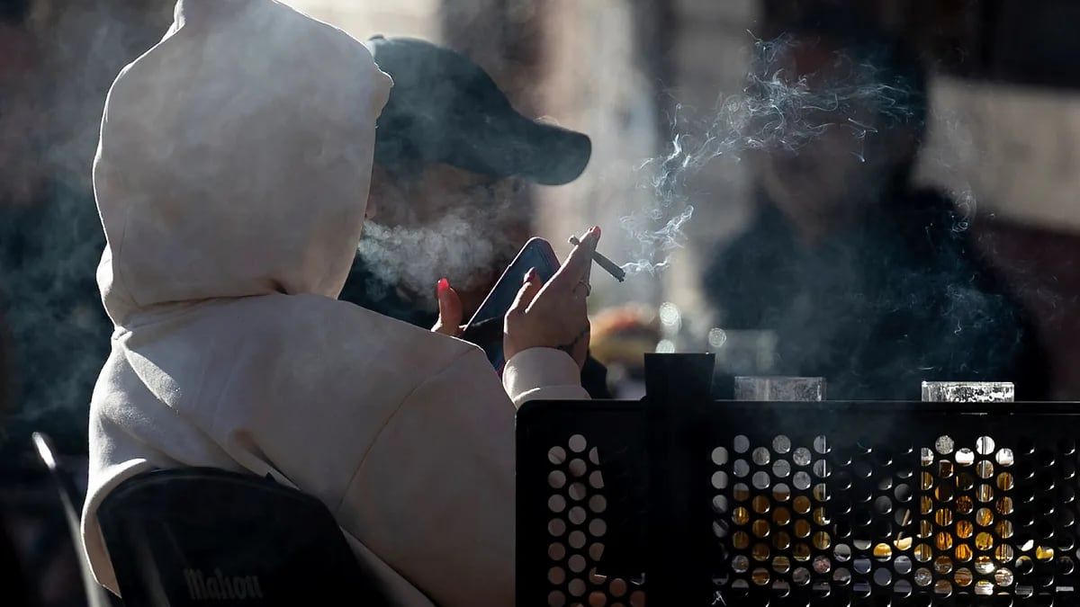 Varias personas fumando en una terraza