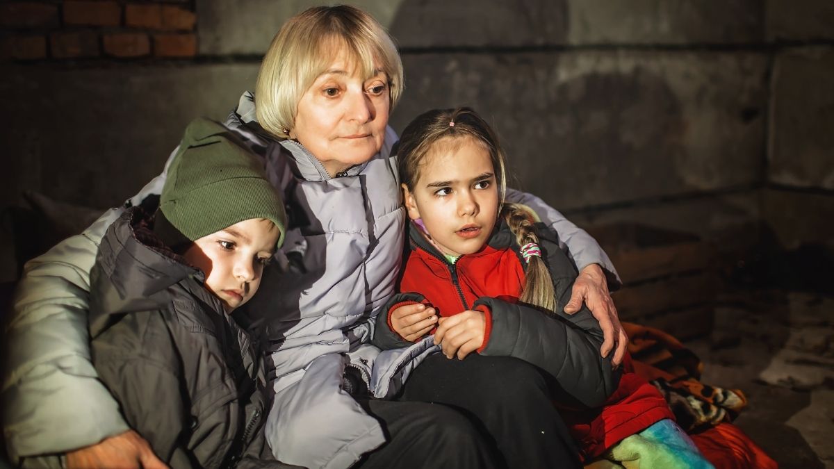 Una mujer abrazada a dos niños