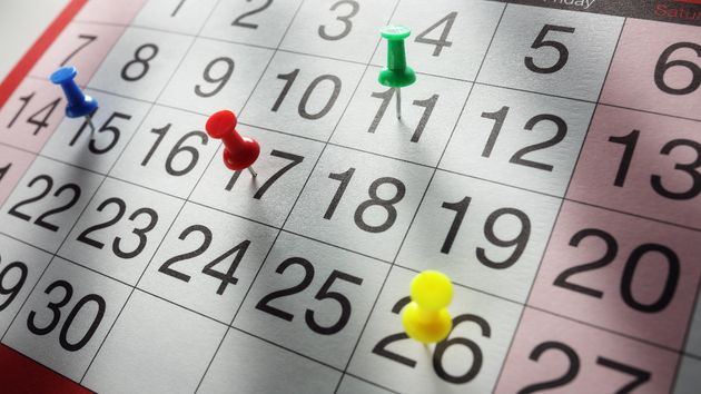 un calendario de la semana con chinchetas