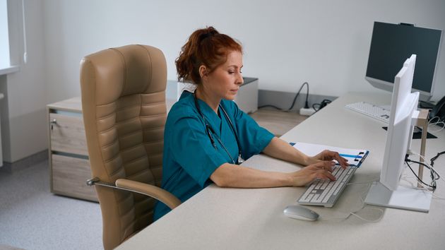 Una mujer trabajando como auxiliar en una clínica dental