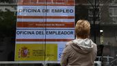 Una mujer mira un cartel en la oficina del SEPE