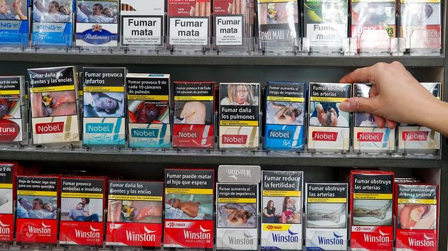 una mano cogiendo una cajetilla de tabaco