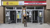 Una mujer delante de una oficina de empleo