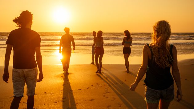 Varias personas caminando en la playa
