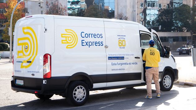 Un trabajador de Correos Express al lado de una furgoneta