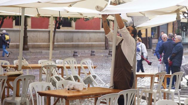 un camarero recoge la terraza
