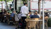 Un camarero atendiendo la terraza de un bar