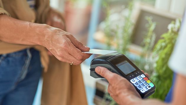 Una mujer pagando con una tarjeta de crédito