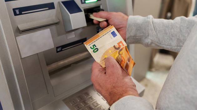 Persona saca dinero cajero automático