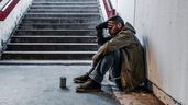 Hombre sin techo en pie escalera