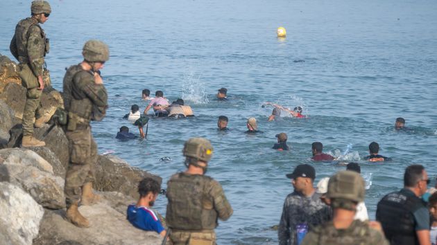 Militares en la frontera mientras los migrantes pasan a nado