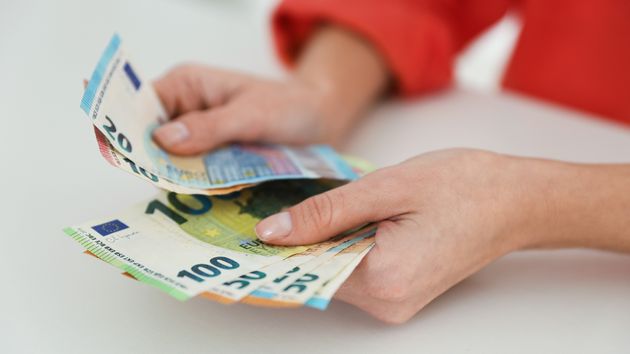 Una mujer contando billetes de euro