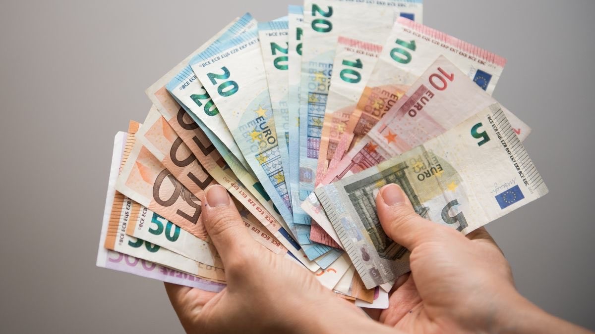 persona sosteniendo billetes de euro